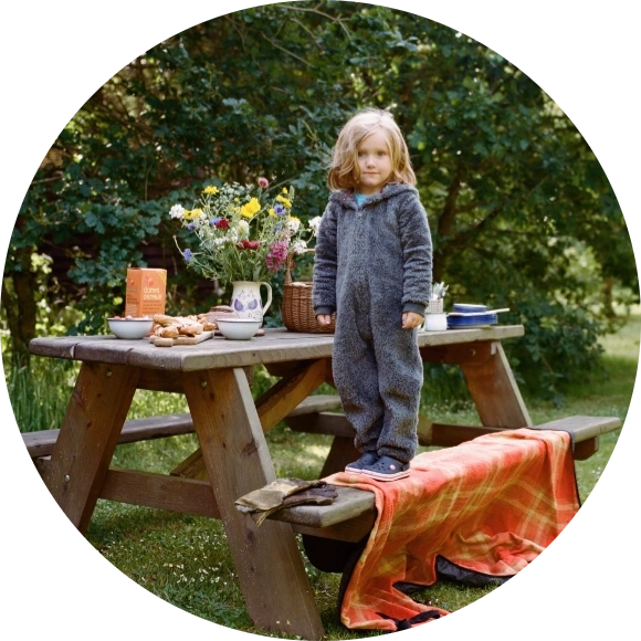 Small child camping outside at Cwtch Camping